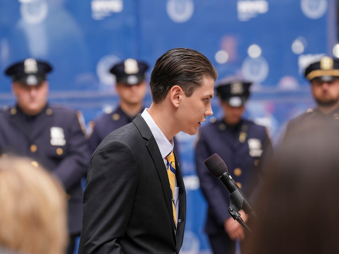 Professional presenter speaking to an audience at a media conference