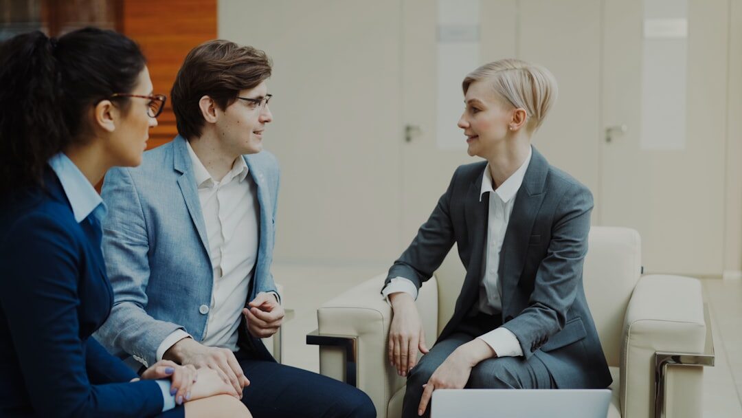 Two journalists conducting a professional interview in a modern setting