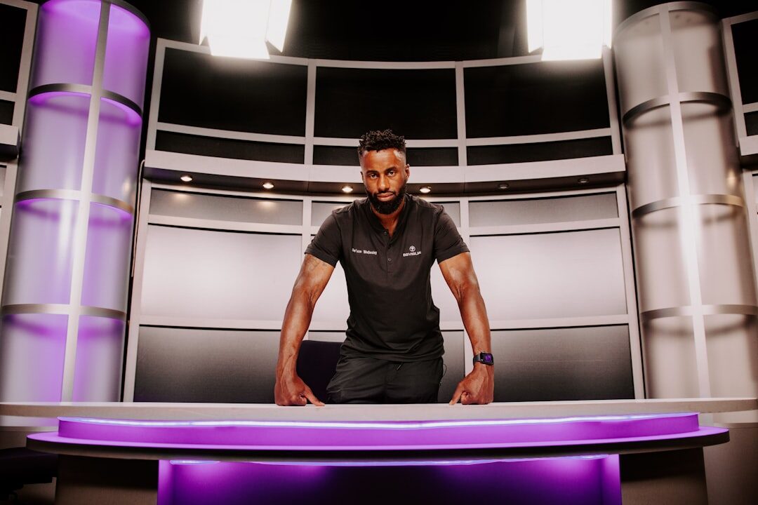 Professional TV news presenter at news anchor desk