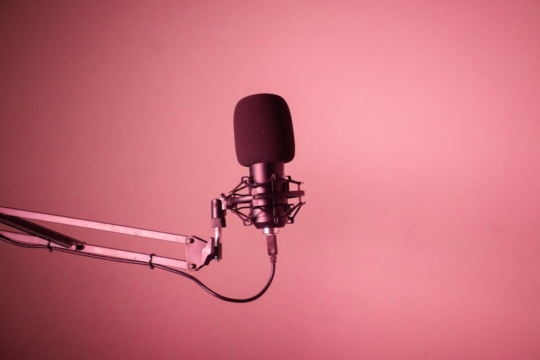 Person recording a podcast with professional microphone in a sound studio